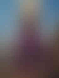 Women's eco-friendly yoga palazzo pants with wrap belt in black, worn by model, made from sustainable materials.