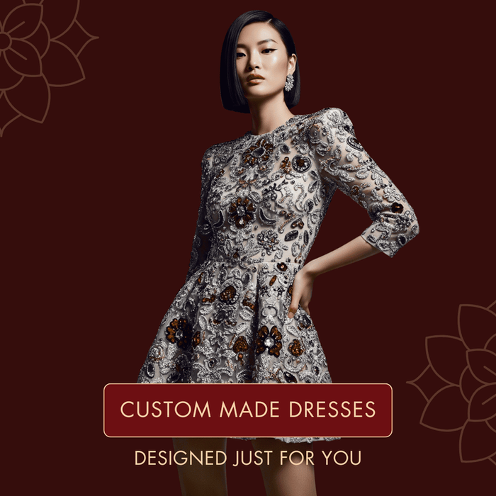 A woman smiles confidently in a perfectly fitted custom-made dress. In the background, fabric swatches and a tape measure are visible, highlighting the bespoke design process of the collection.