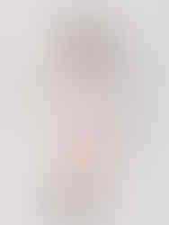 A photo of a woman wearing a Cusuti 100% cotton batwing top. The top is flowy and has a loose fit.