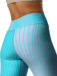 A woman confidently doing a yoga pose while wearing CoastFlex Sport Leggings in a stylish color