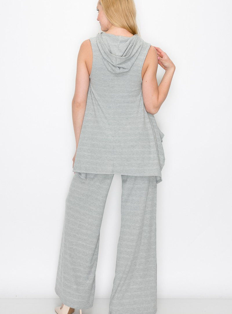 A woman wearing a Cusuti two-piece set featuring a relaxed-fit hooded top with a front pocket and flowy maxi-length, wide-leg