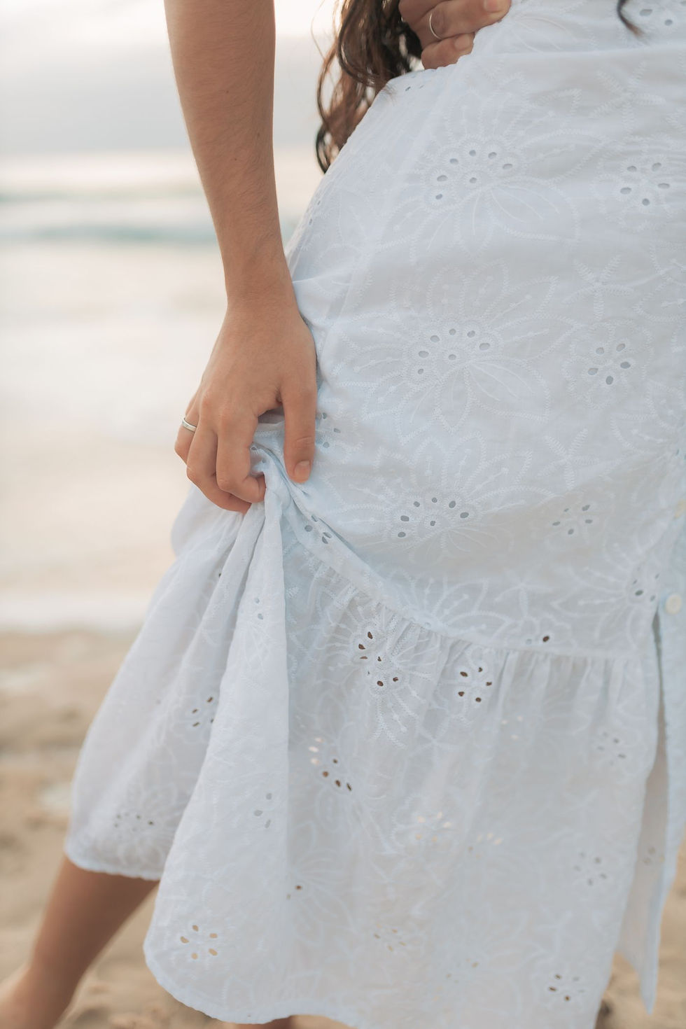 Woman in a white broderie anglaise eyelet dress