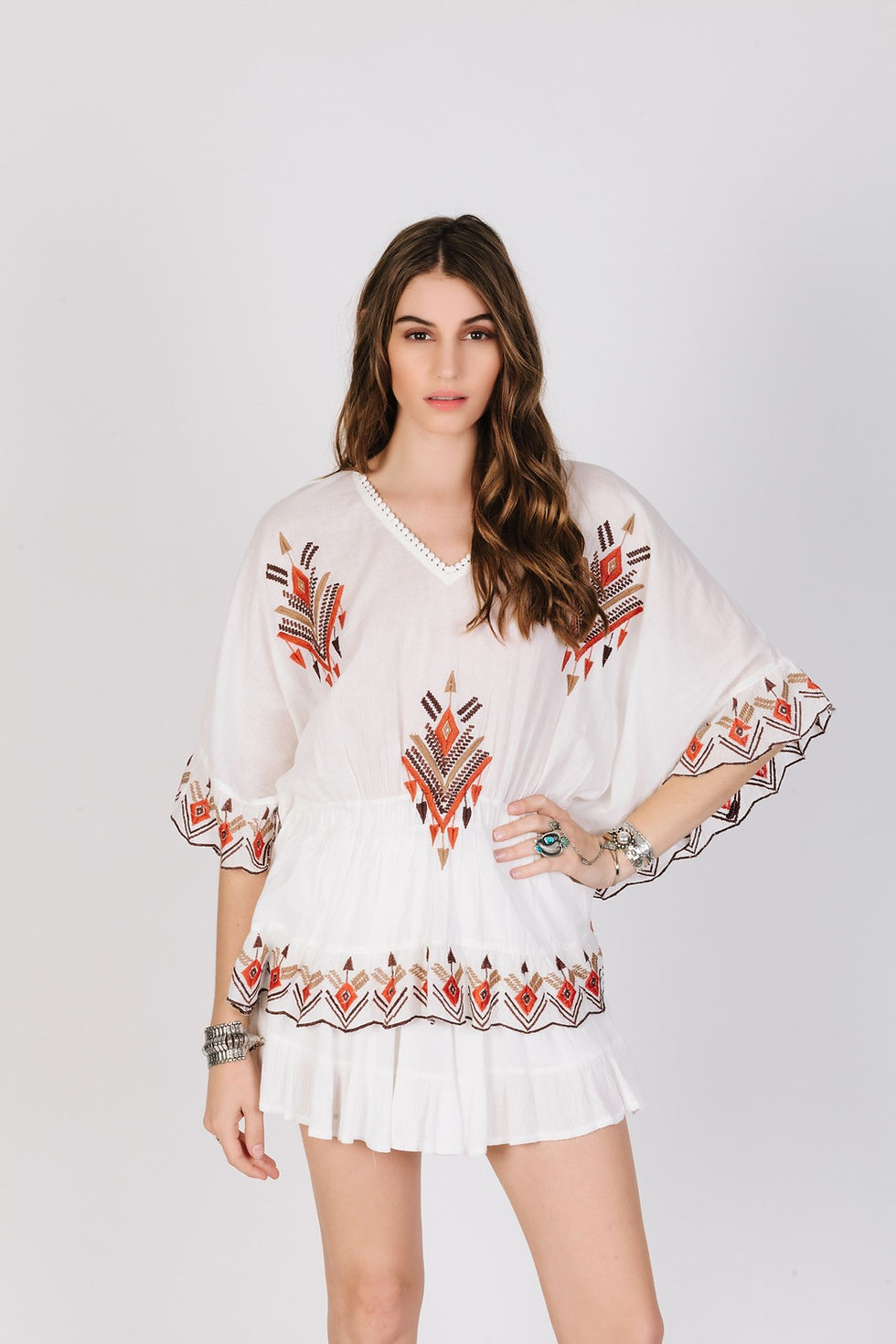 A photo of a woman wearing a Cusuti 100% cotton batwing top. The top is flowy and has a loose fit.