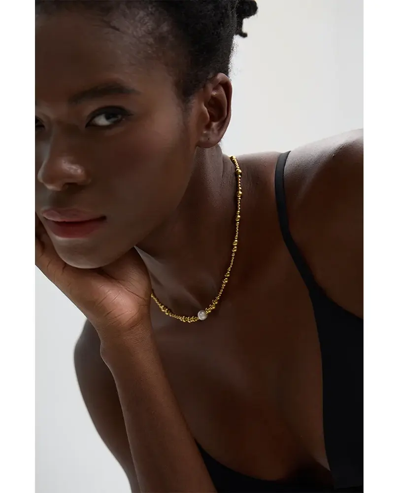 Features a trendy geometric design with a gleaming gold-plated finish, centered with a single, elegant freshwater pearl.