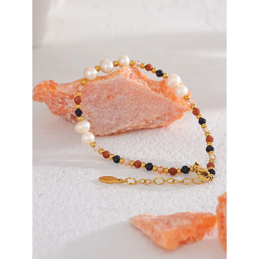 Freshwater pearl charm bracelet with a trendy geometric design. Tarnish-resistant gold-plated stainless steel.