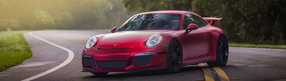 Red satin color change car wrap on a high-performance sports car, showcasing premium vinyl wrap finish and professional automotive styling for custom vehicle wraps.