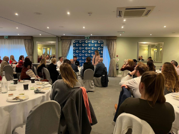 Jess Brown-Fuller delivering a talk in front of guests at a Chichester Chamber of Commerce Breakfast event