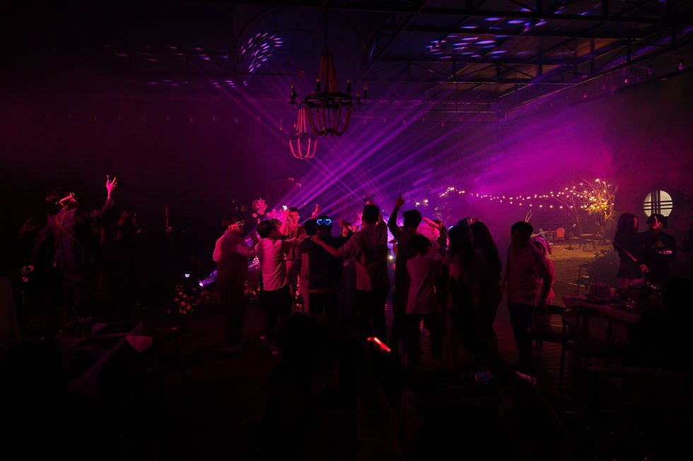 Guests enjoying a night event with lights and music at Dalat Train Village