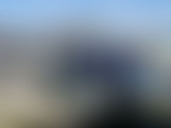 Five people stand on a dock next to a NOAA survey boat, with a marina in the background. 