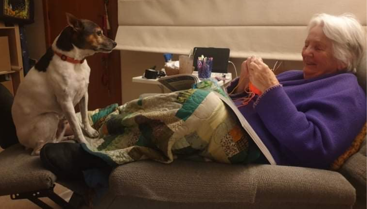 Pamela at home with her work and her dog