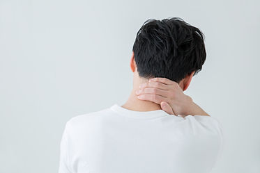 痛みで首を押さえる男性