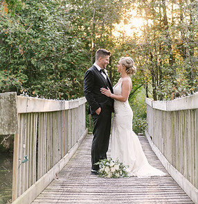 Newlyweds on bridge over Logan Creek at Fernwood Gardens Ballroom, Door County, WI