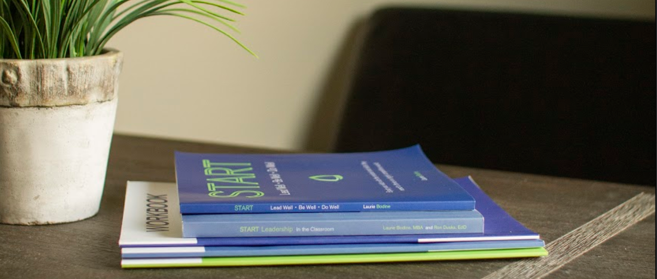 START Books on Desk Image.png