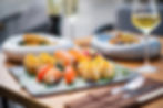 A sushi platter paired with two glasses of wine