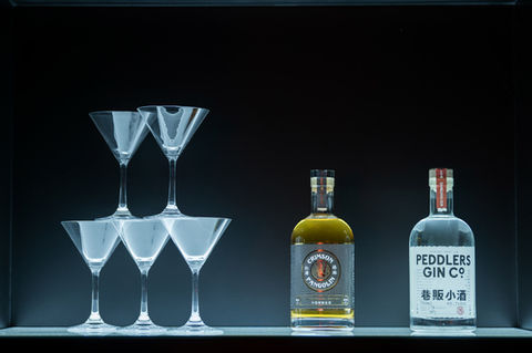 Close-up of signature cocktail with branded garnish at launch event