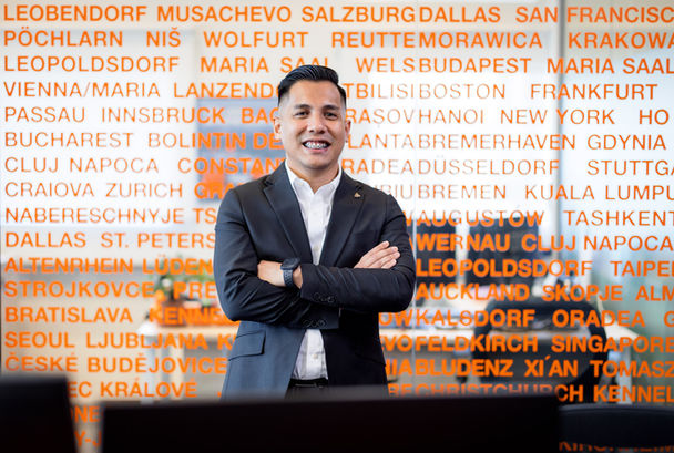 Professional headshot of business leader with warm office lighting