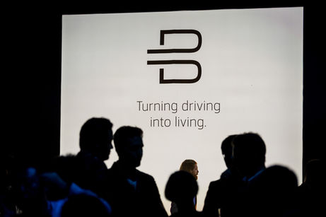 Silhouettes of people gathering at a car launch in Shanghai