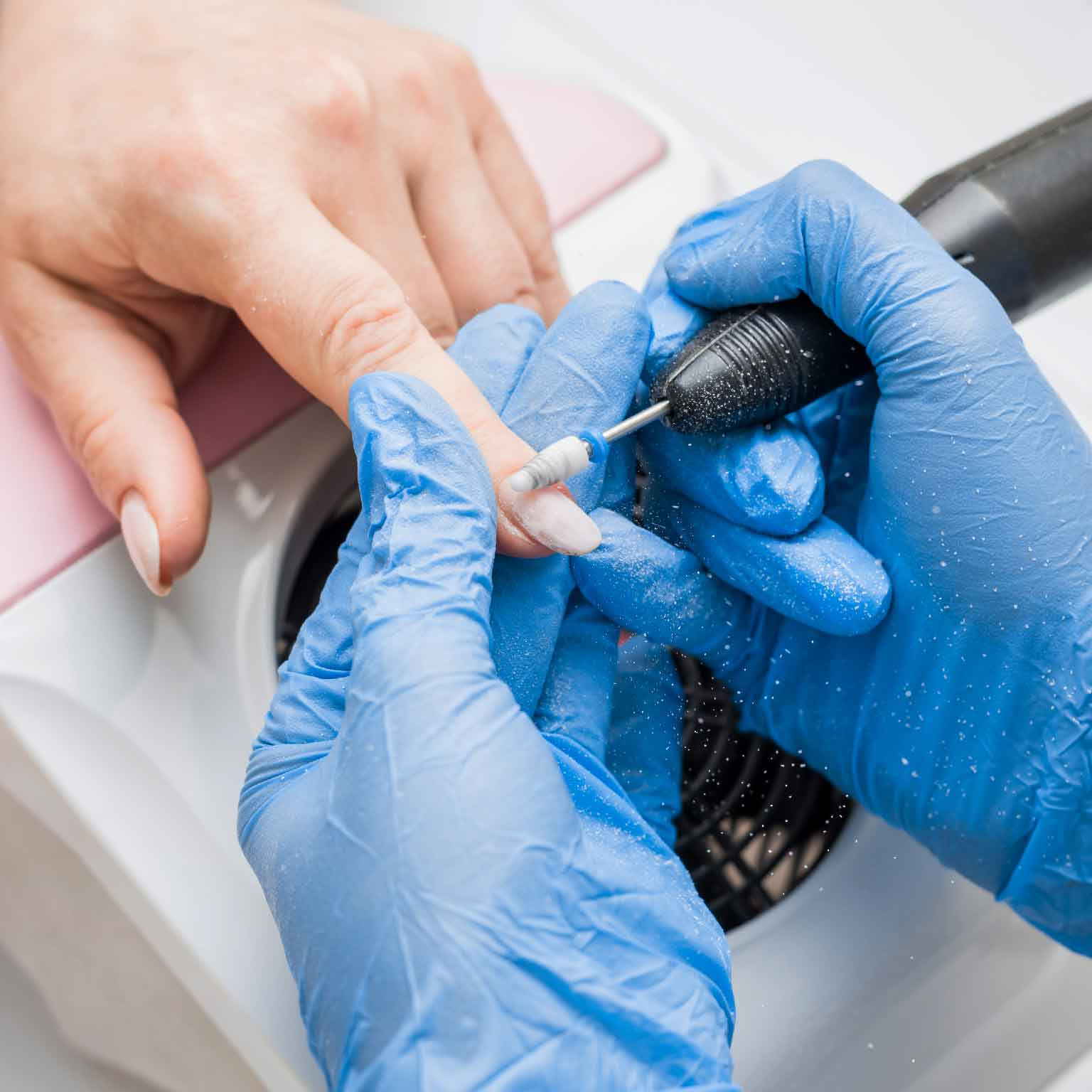 nail drill working on fingernail