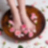 kid's feet inside a bowl filled with flowers