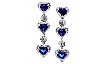 18k White Gold Drop Earrings featuring 7.22 carats of heart shaped Royal Blue Sapphires and 2.69 carats of diamonds