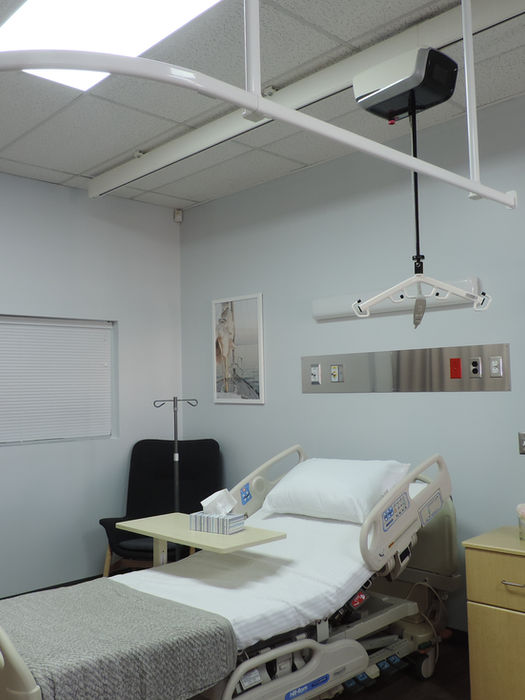 Curved hospital curtain track system mounted on the ceiling