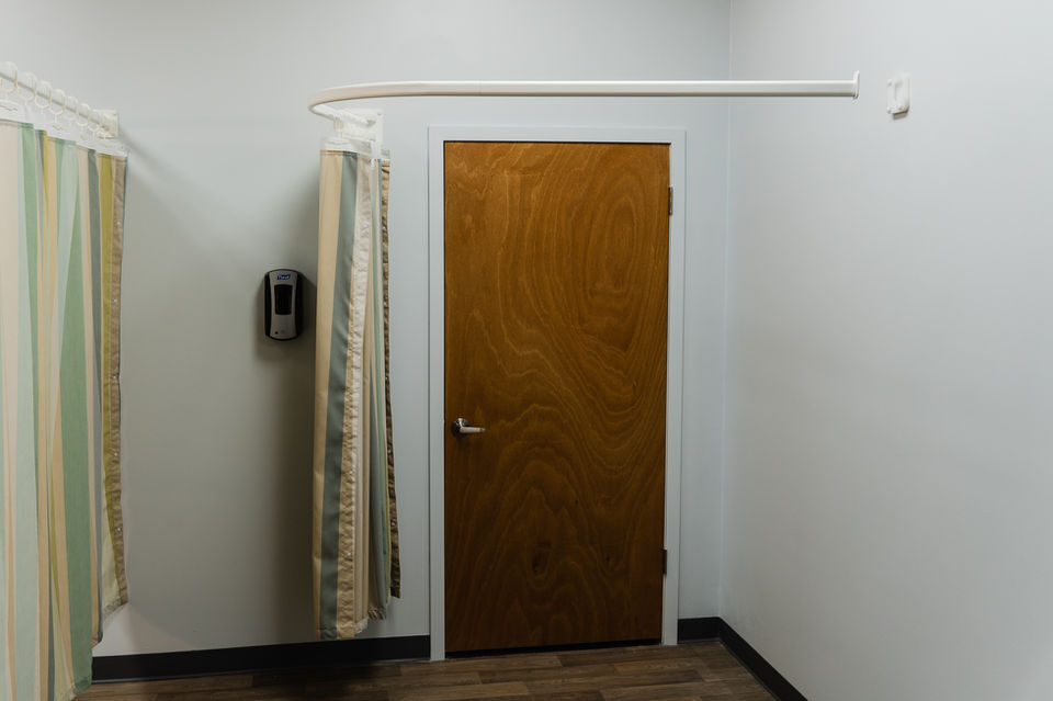 Curved curtain track used in healthcare facilities for flexible room division