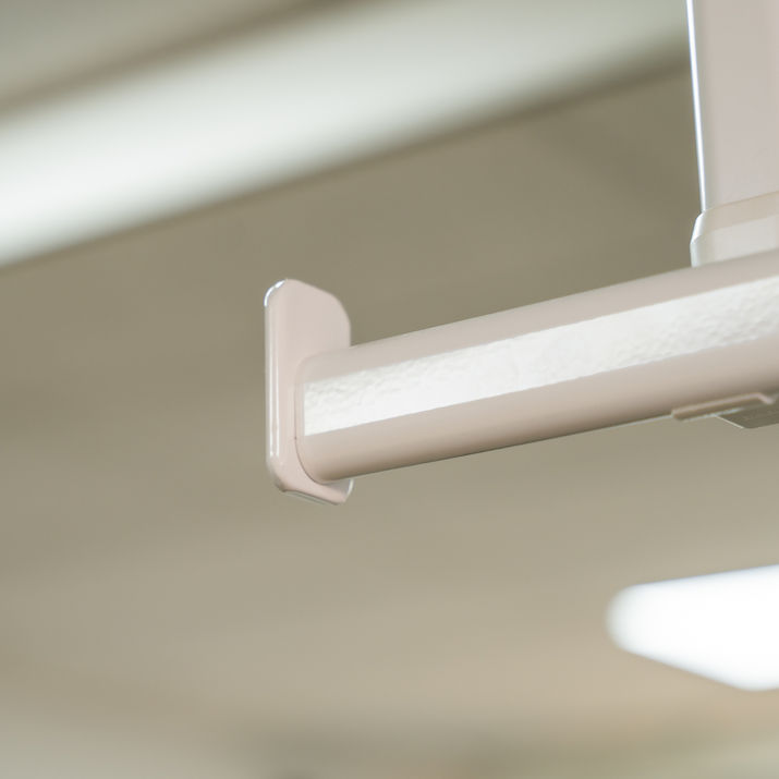 Close-up of ceiling-mounted hospital curtain track with gliders