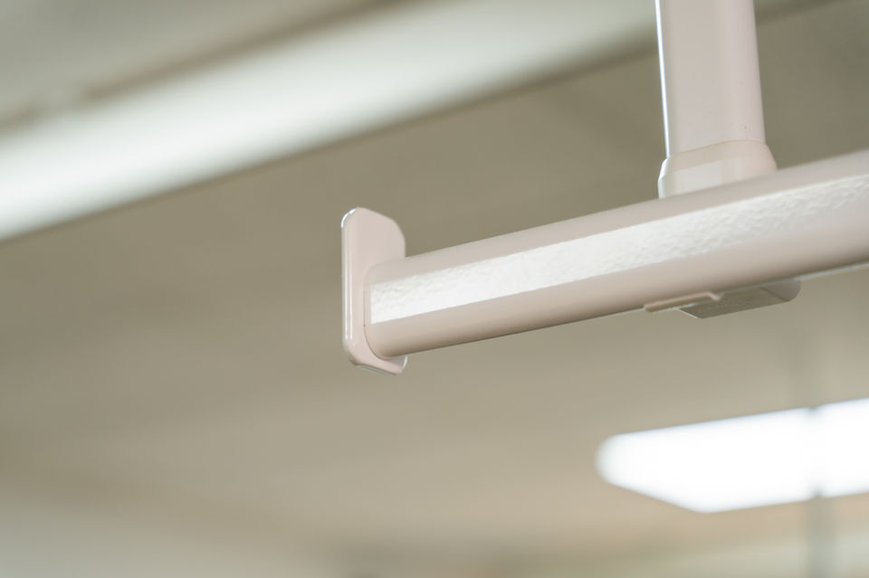 Close-up view of hospital curtain track system mounted to the ceiling