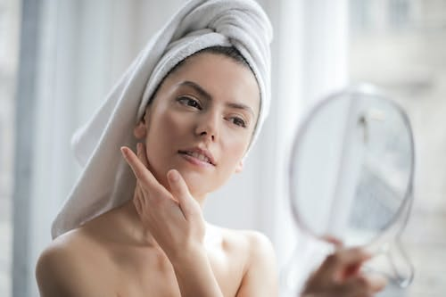 A woman looking at the mirror