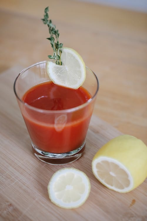 Fresh,Nutritious and Delicious Tomato Juice served in a glass with a slice of Lemon.