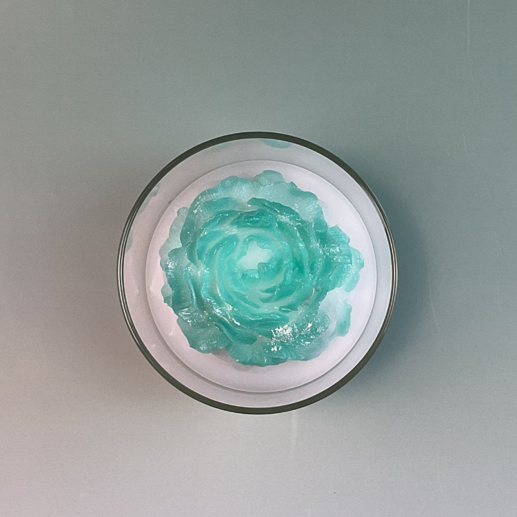 Forest Calm eucalyptus candle in 17oz glass jar top view of forest green peony wax flower.