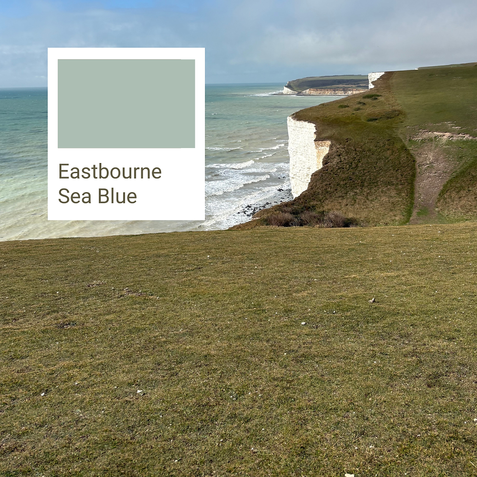 Cliffside view of the sea with green grass in the foreground. A swatch labeled "Eastbourne Sea Blue" matches the water's color. Calm mood.