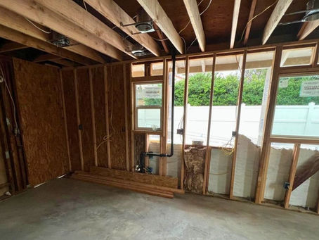 In-progress ADU construction framed with exposed wood beams and windows by Dynamic Quality Builders in Southern California.