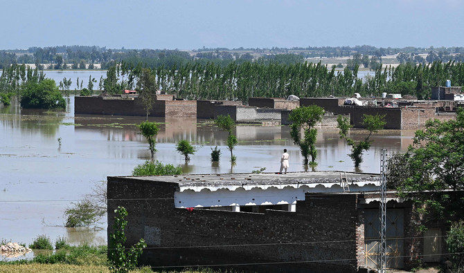 A man stands on the roof of his flooded house after heavy rains in Nowshera district, Khyber-Pakhtunkhwa province, on April 16, 2024. 