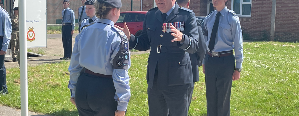 Air Commodore Simon Harper speaks to the cadets as he walks through the guard of honour.