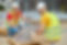 two-workers-stacking-bricks-looking-at-camera-2021-12-17-03-57-42-utc.jpg