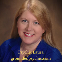 Smiling woman in blue shirt, brown background. Text: "Psychic Laura" and "groundedpsychic.com" in yellow. Calm and inviting mood.