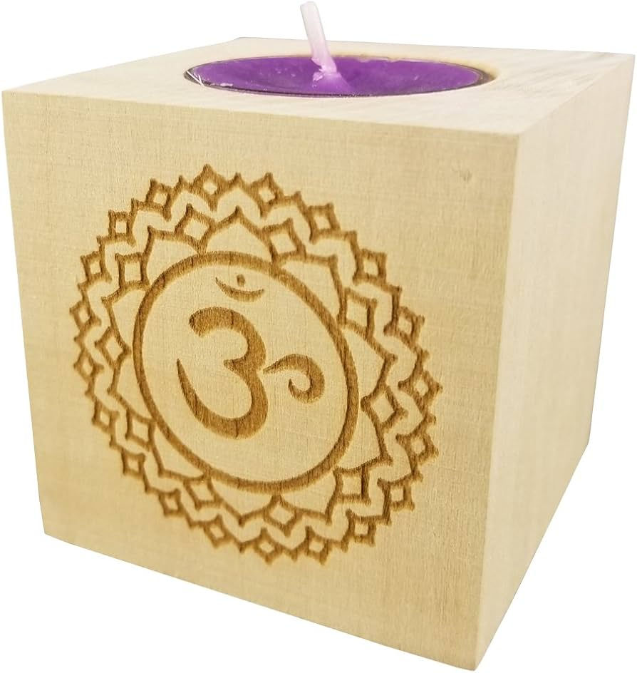 Wooden tealight holder with a carved Om symbol and lotus pattern. A purple candle is seated inside the holder, creating a serene mood.