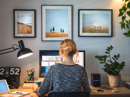 Person working on a laptop at home with insurance documents on the desk