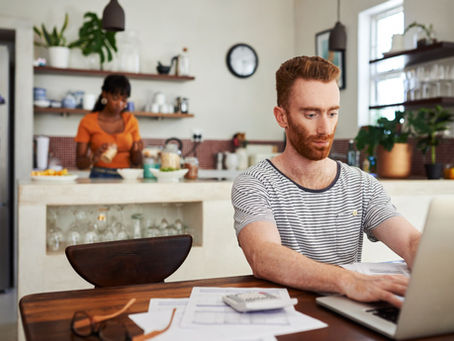 Person reviewing UK credit card options on a laptop with a low credit score notification