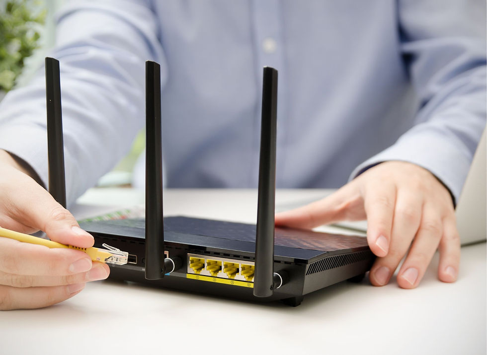 Man checking broadband deal options on a laptop at home in the UK