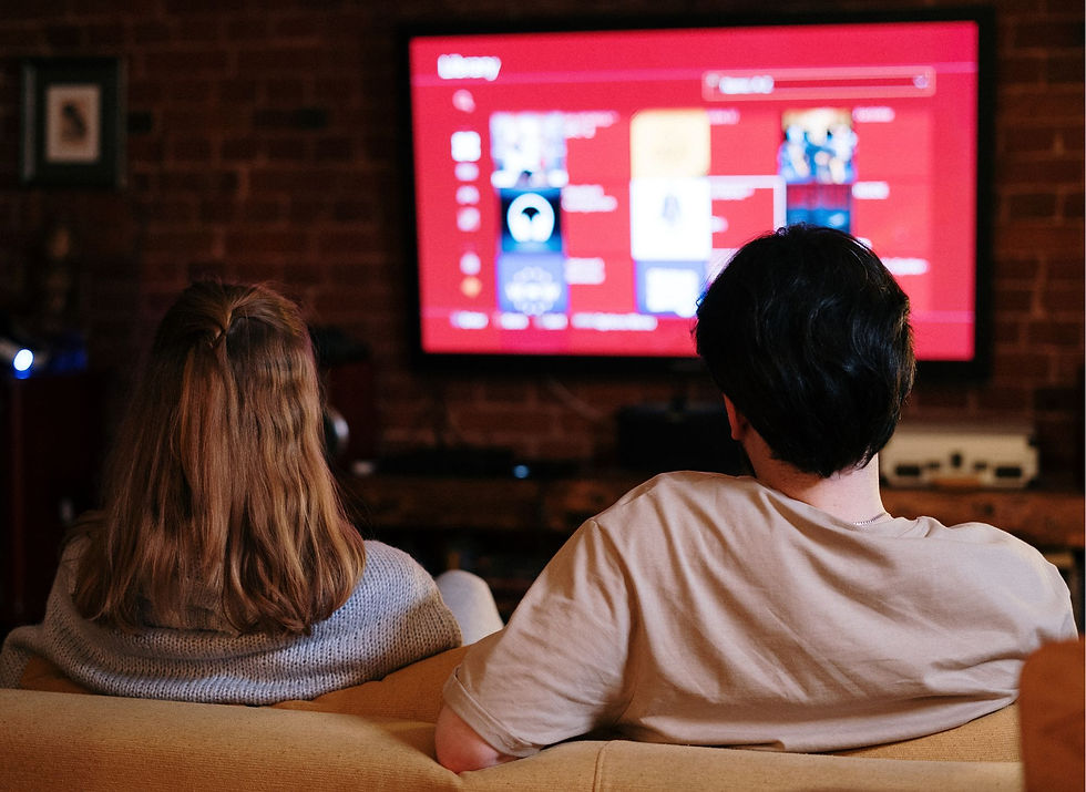 Person watching Netflix on a laptop with a buffering icon on screen