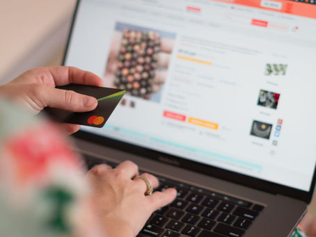UK shopper using a credit card to make a secure online purchase via laptop