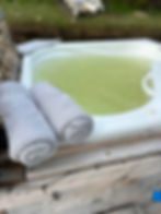 Outdoor hot tub with towels for a geodome project showcase.