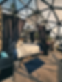 Interior of a geodome project showcase with a bed.