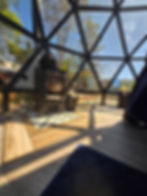 Interior of a geodome project showcase with a wood stove.
