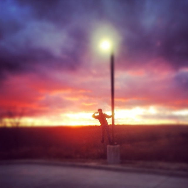 A photo of me taking a photo of a sunset.