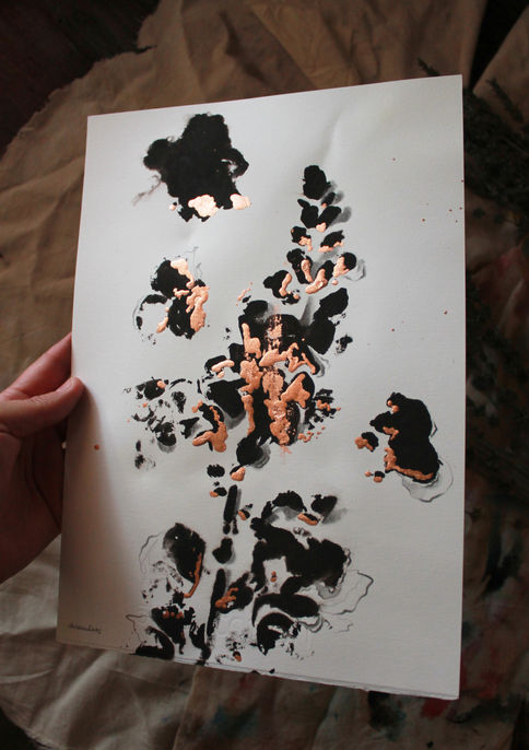 Paper showing a print of plants in black, with copper foil