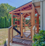 Custom cedar catio in Beaverton, Oregon built by The Catio Company, feauturing polycarbonate roof, climbing ramps, and spacious outdoor enclosure for cats.