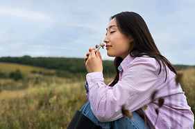 side-view-woman-smelling-flower.jpg